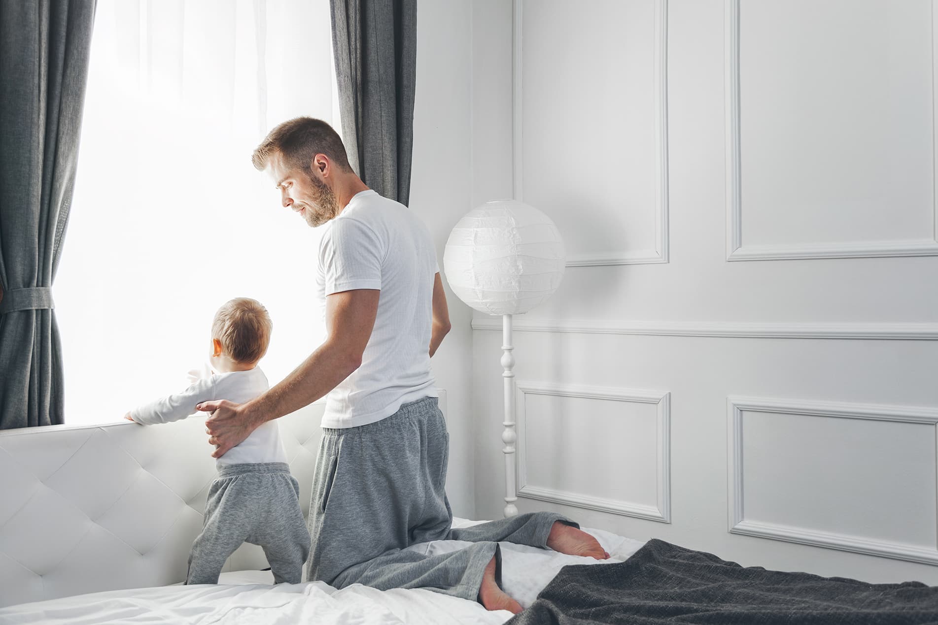 father and son looking out of window