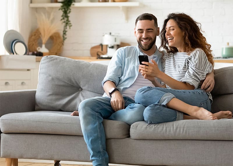 couple on sofa looking at new homes