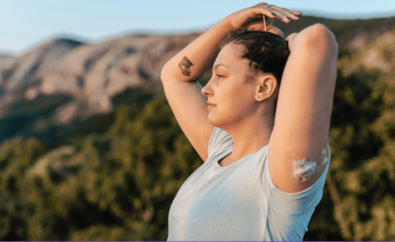 woman outside tying her hair up
