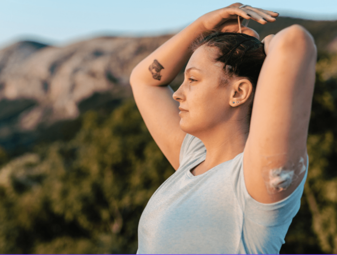 woman outside tying her hair up