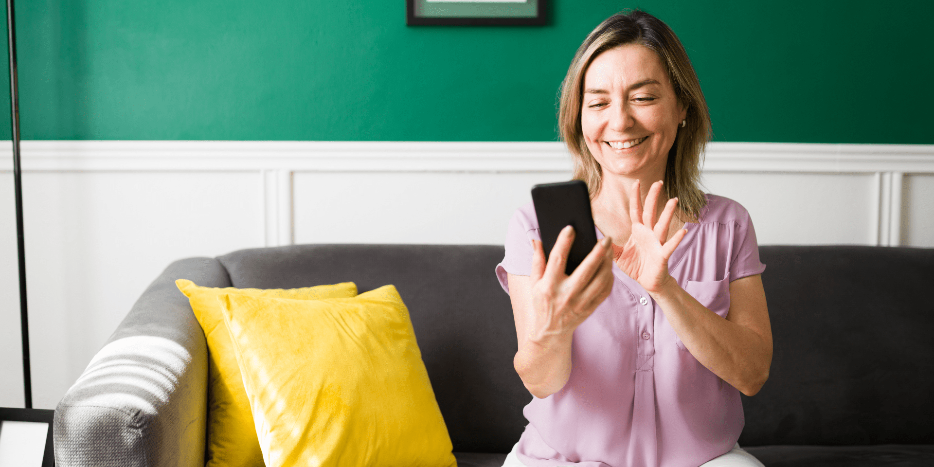 woman smiling at her phone