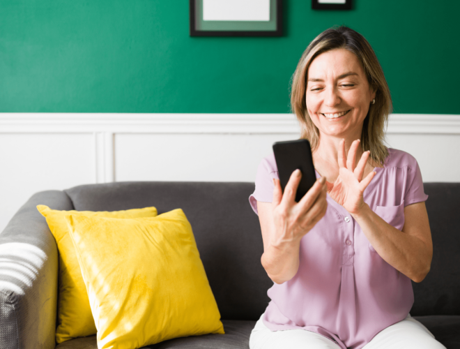 woman smiling at her phone