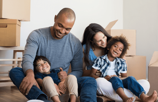 family in their house with moving boxes