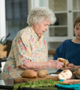 old woman peeling potatoes