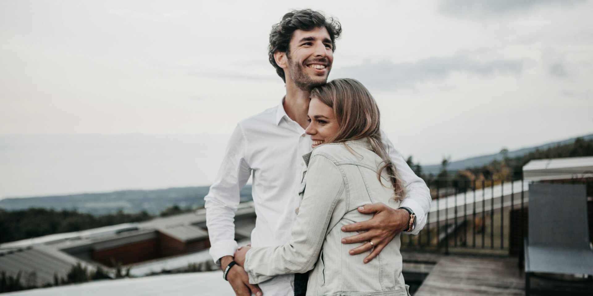 couple hugging and smiling on a terrace