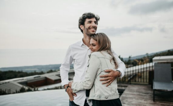 couple hugging and smiling on a terrace