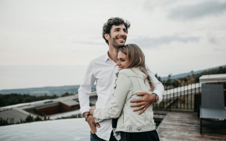 couple hugging and smiling on a terrace